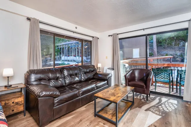 a living room with furniture and a floor to ceiling window