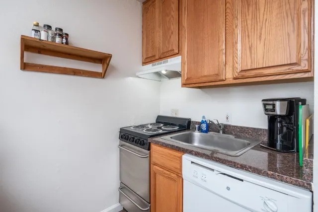 a kitchen with stainless steel appliances granite countertop a sink and a microwave