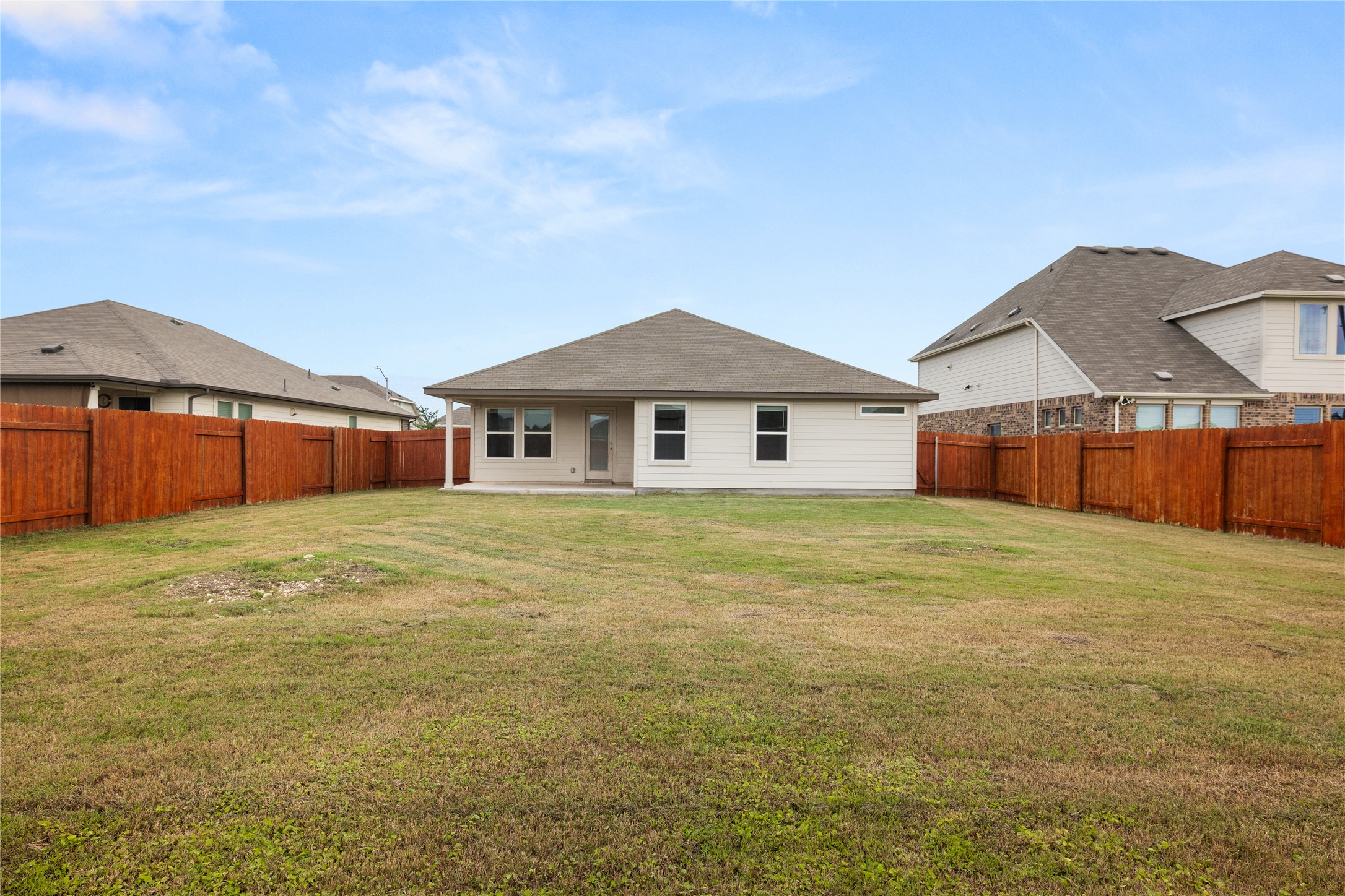 105 Saviano Road Hutto, TX 78634 - Photo 17 of 22 A spacious backyard with privacy fencing, perfect for outdoor activities and future enhancements.