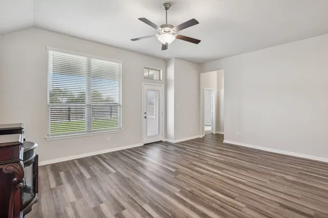 wooden floor in an empty room with a window