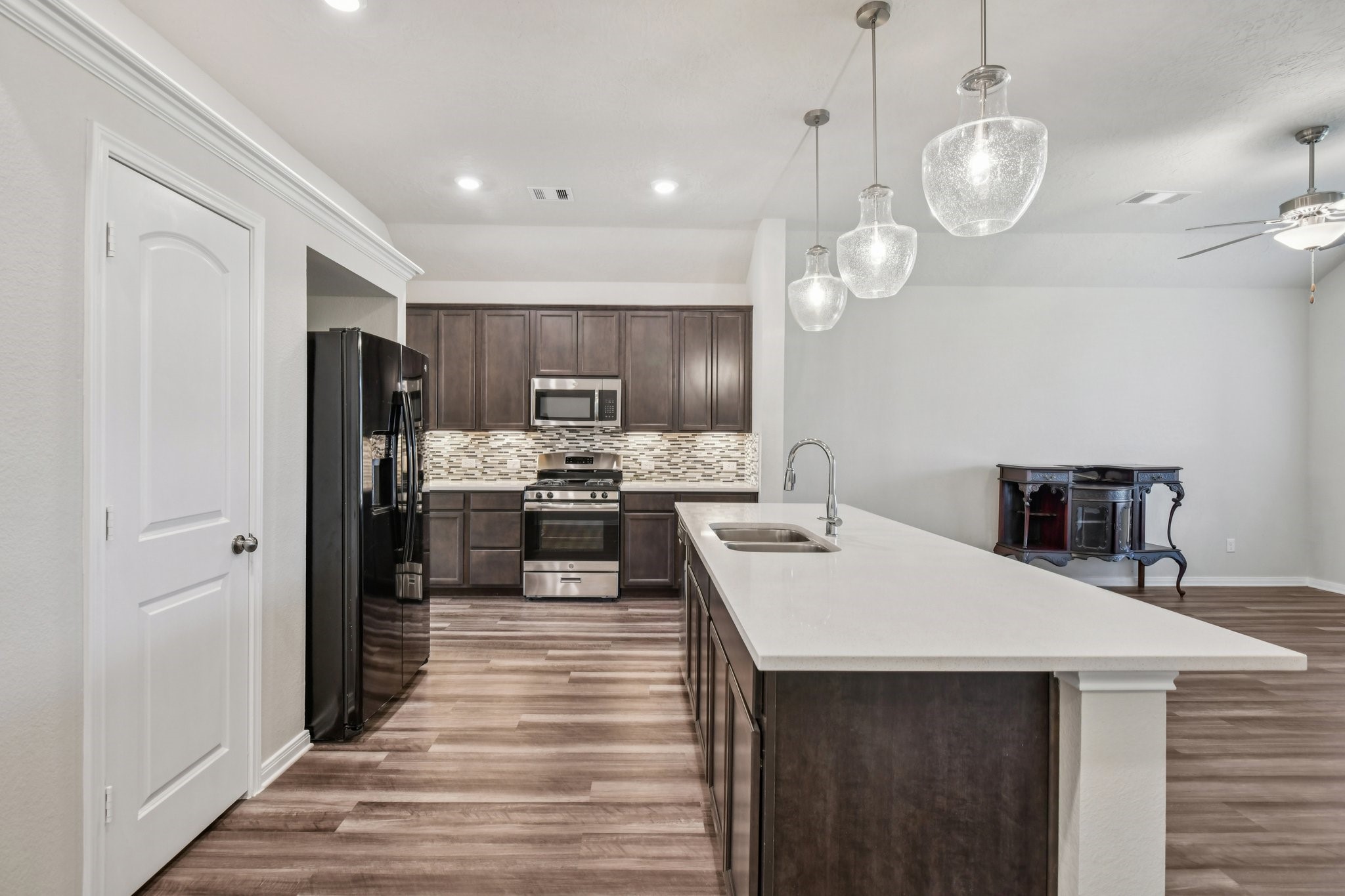 199 Racetrack Lane Montgomery, TX 77356 - Photo 40 of 40 a kitchen with a sink stainless steel appliances and chandelier