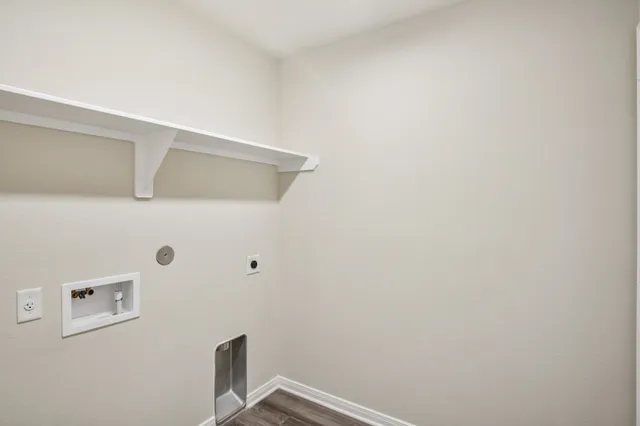 a kitchen with a sink and wooden floor