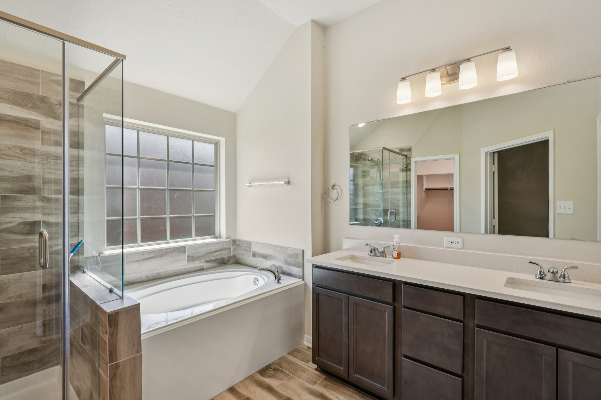 199 Racetrack Lane Montgomery, TX 77356 - Photo 30 of 40 a bathroom with a tub sink and mirror