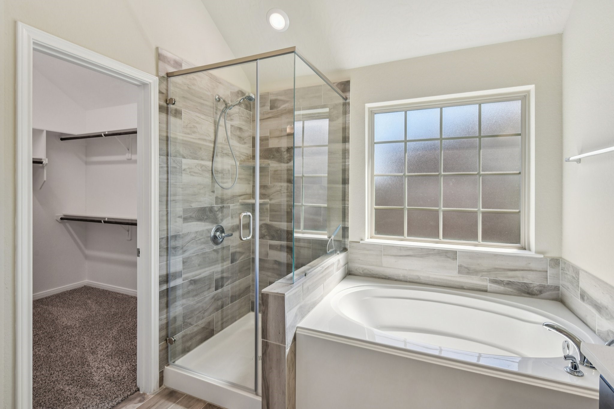 199 Racetrack Lane Montgomery, TX 77356 - Photo 31 of 40 a bathroom with a bathtub and a shower