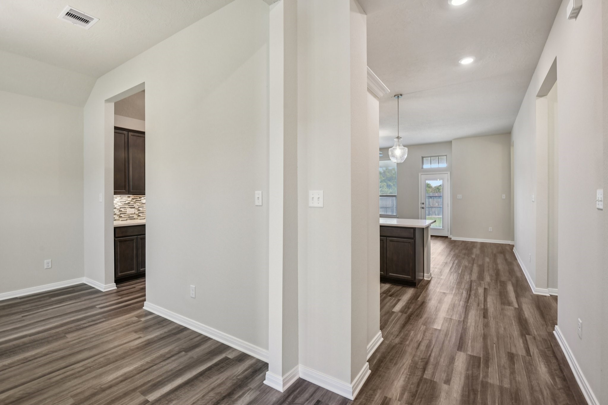 199 Racetrack Lane Montgomery, TX 77356 - Photo 4 of 40 a view of a hallway with wooden floor and staircase