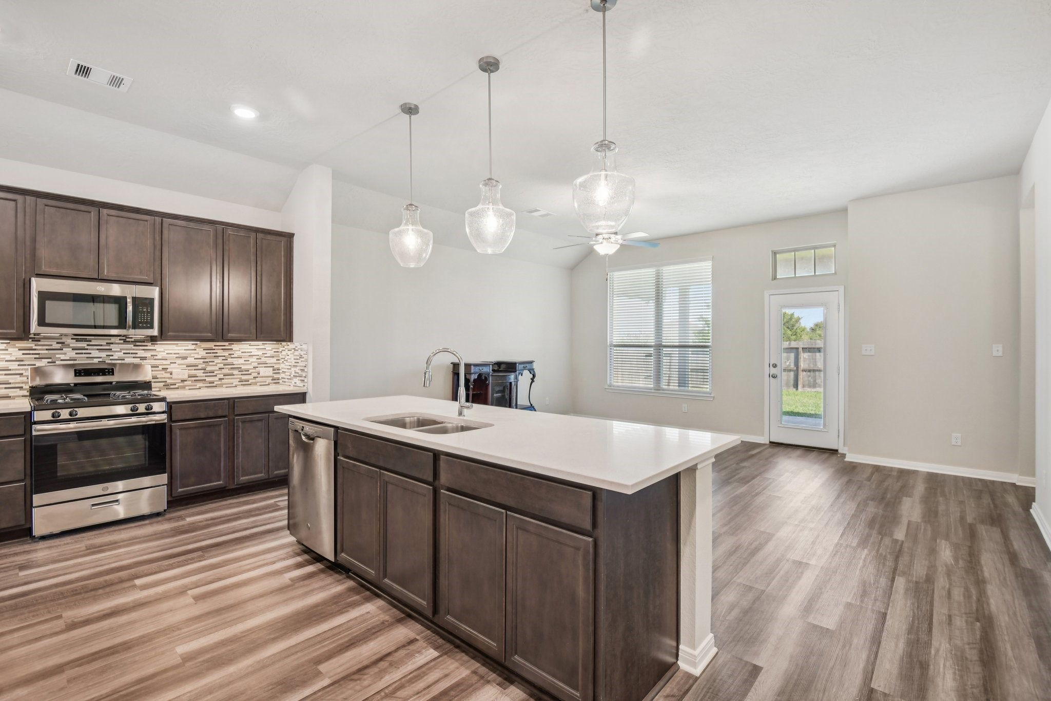 199 Racetrack Lane Montgomery, TX 77356 - Photo 9 of 40 a large kitchen with a large center island a sink stainless steel appliances and cabinets