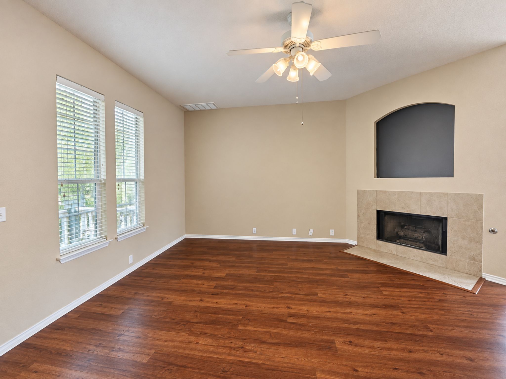 5679 Fergus, Unit B Kyle, TX 78640 - Photo 8 of 26 Rich wood floors anchor this inviting room highlighted by a classic tiled fireplace.