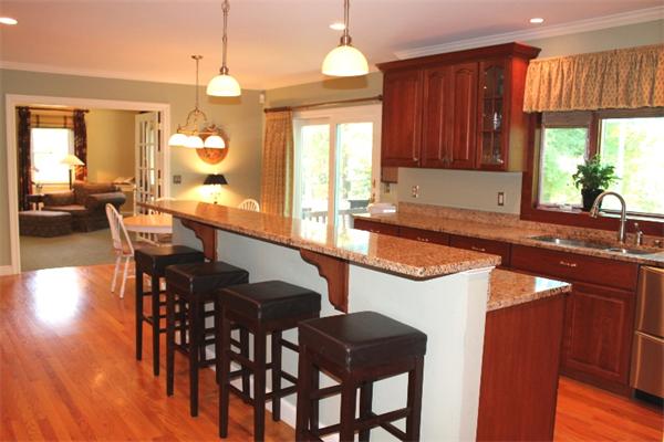 28 Columbus Street Lexington, MA 02421 - Photo 11 of 27 a kitchen with stainless steel appliances granite countertop a table chairs sink and cabinets