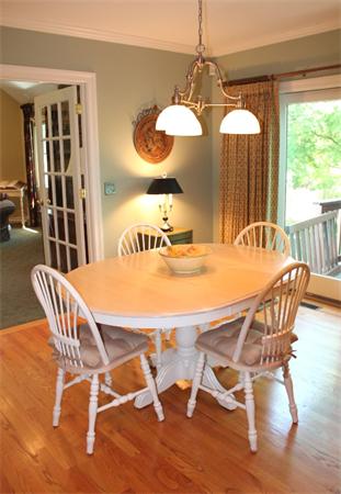 28 Columbus Street Lexington, MA 02421 - Photo 12 of 27 a dining room with wooden floor a chandelier a glass table and chairs
