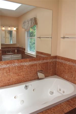 28 Columbus Street Lexington, MA 02421 - Photo 15 of 27 a bathroom with a tub and a large window