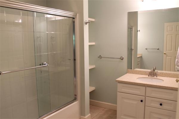28 Columbus Street Lexington, MA 02421 - Photo 20 of 27 a bathroom with a shower sink and mirror