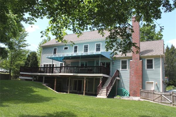 28 Columbus Street Lexington, MA 02421 - Photo 25 of 27 a view of a house with a backyard and a large tree