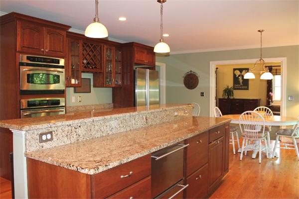 28 Columbus Street Lexington, MA 02421 - Photo 9 of 27 a kitchen with stainless steel appliances granite countertop a stove a sink and a wooden cabinets