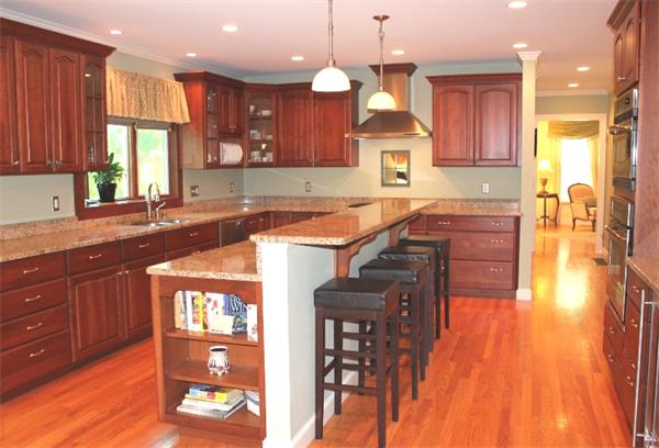 28 Columbus Street Lexington, MA 02421 - Photo 10 of 27 a kitchen with stainless steel appliances granite countertop wooden cabinets a sink dishwasher a stove and a dining table with wooden floor