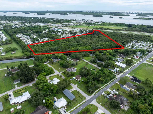 a view of a multi story building with a yard and lake view