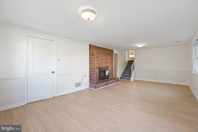 a view of empty room with a fireplace