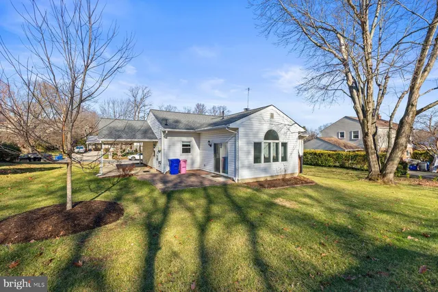 a front view of house with yard and trees