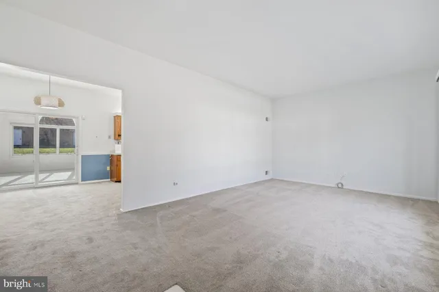 an empty room with an entryway and fireplace