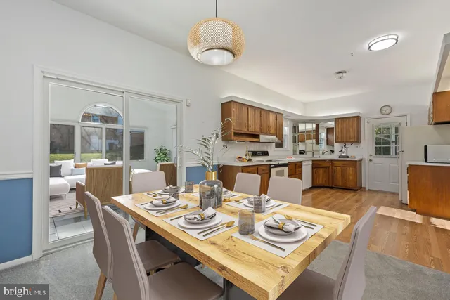 a view of a dining room with furniture and a kitchen