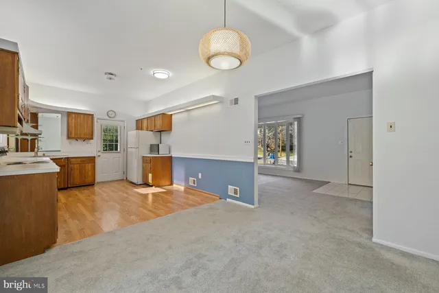a view of a livingroom with a kitchen and a sink