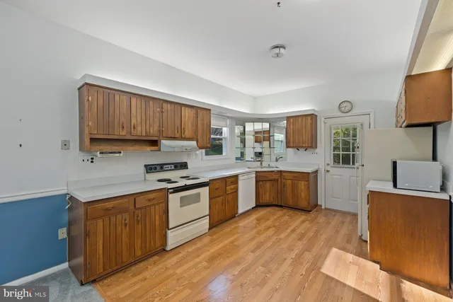 a large kitchen with a wooden cabinets and wooden floor