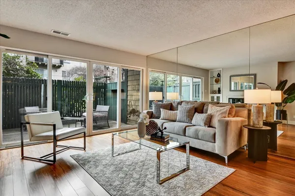 a living room with furniture and a wooden floor