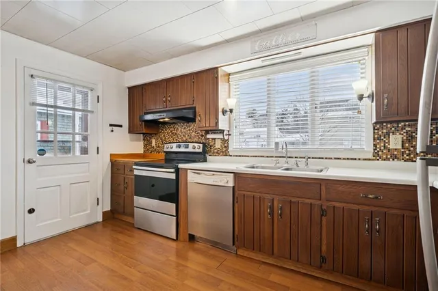 a kitchen with a stove a sink and a microwave