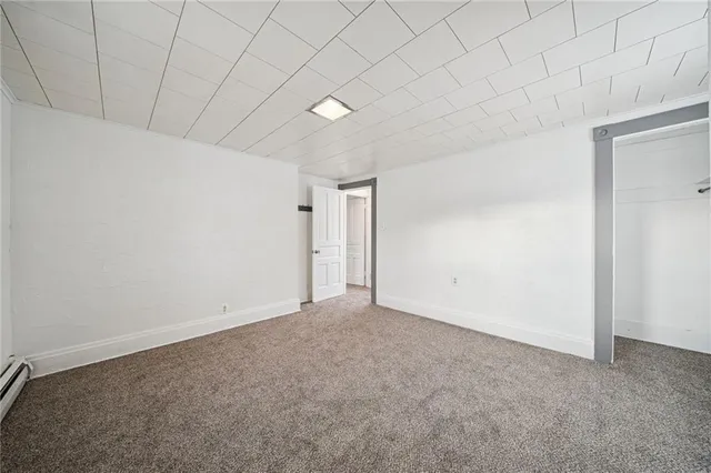 a view of an empty room and a window