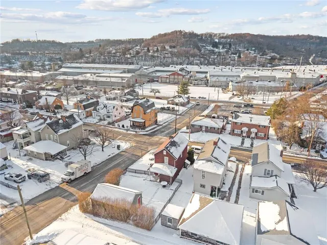 an aerial view of residential houses with city view