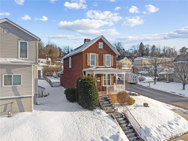 a view of a house with a lounge chairs in a patio