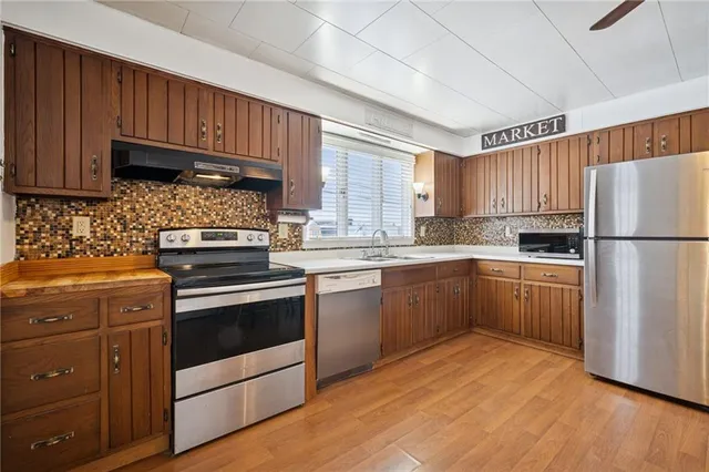 a kitchen with wooden cabinets and white appliances
