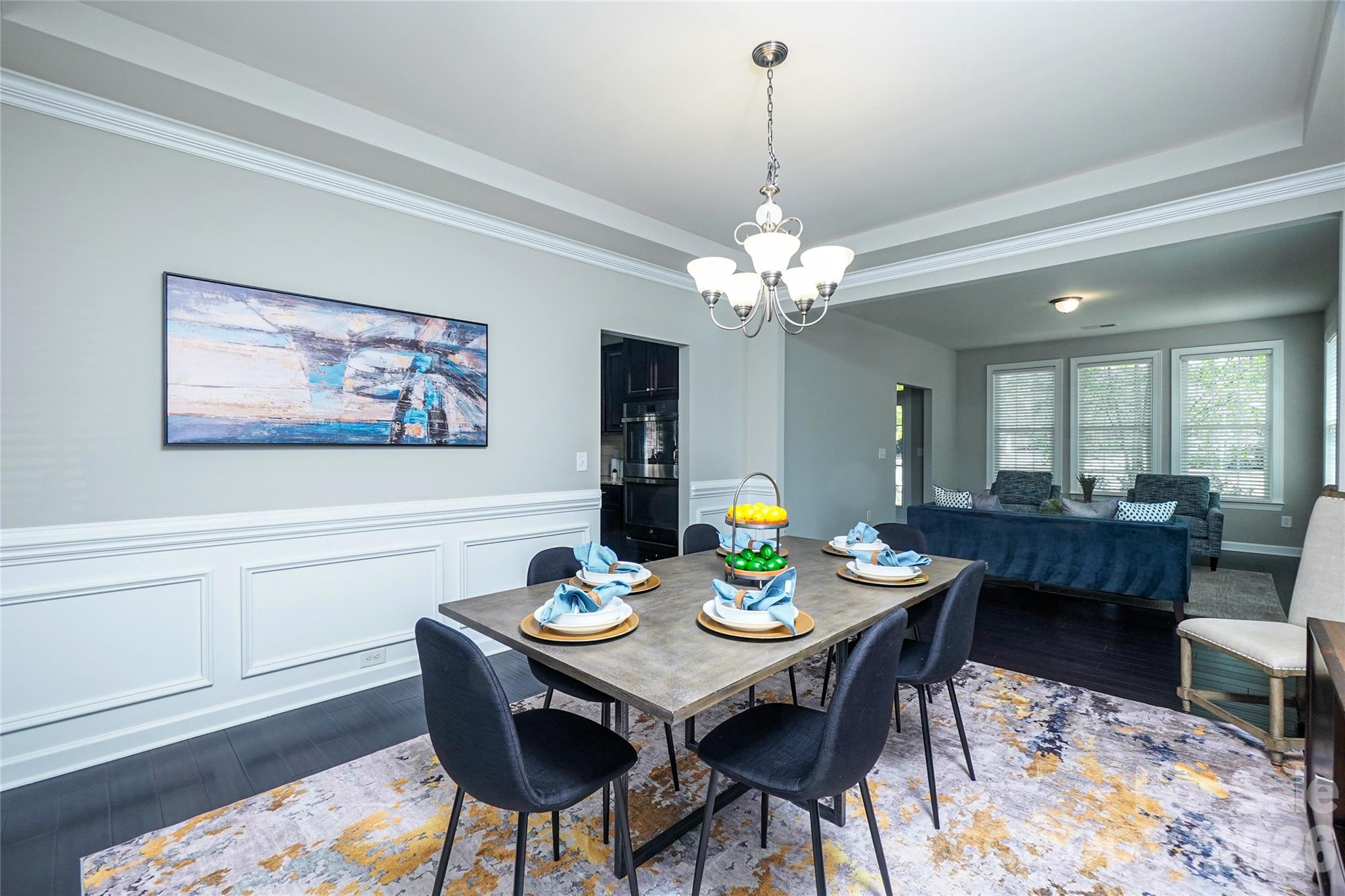 4008 Oxford Mill Road Waxhaw, NC 28173 - Photo 11 of 44 a view of a dining room and livingroom with furniture a rug and wooden floor