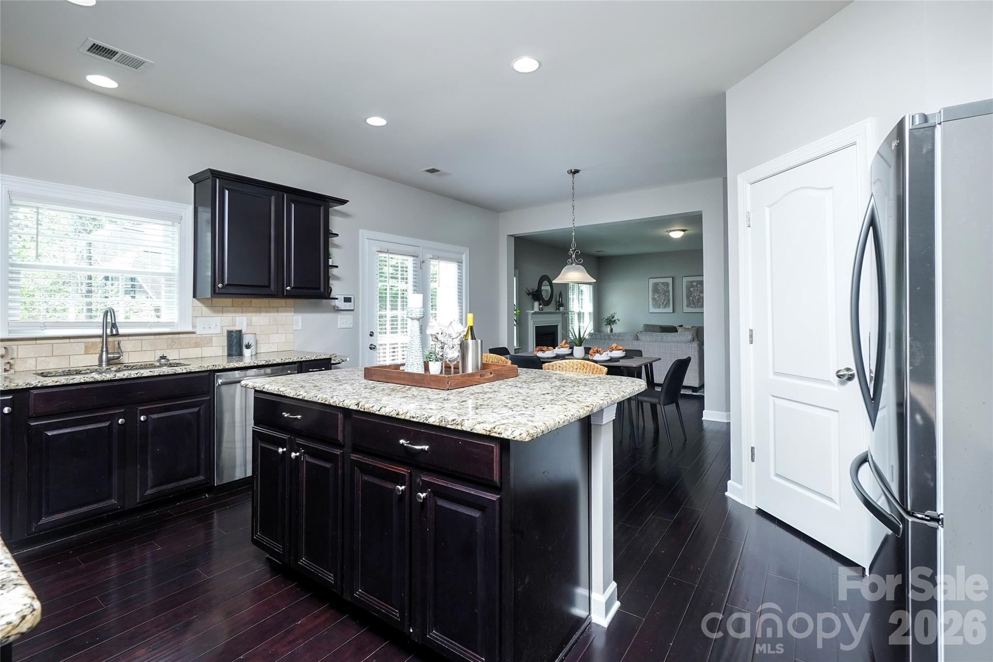 4008 Oxford Mill Road Waxhaw, NC 28173 - Photo 13 of 44 a kitchen with stainless steel appliances granite countertop a sink a stove and a refrigerator