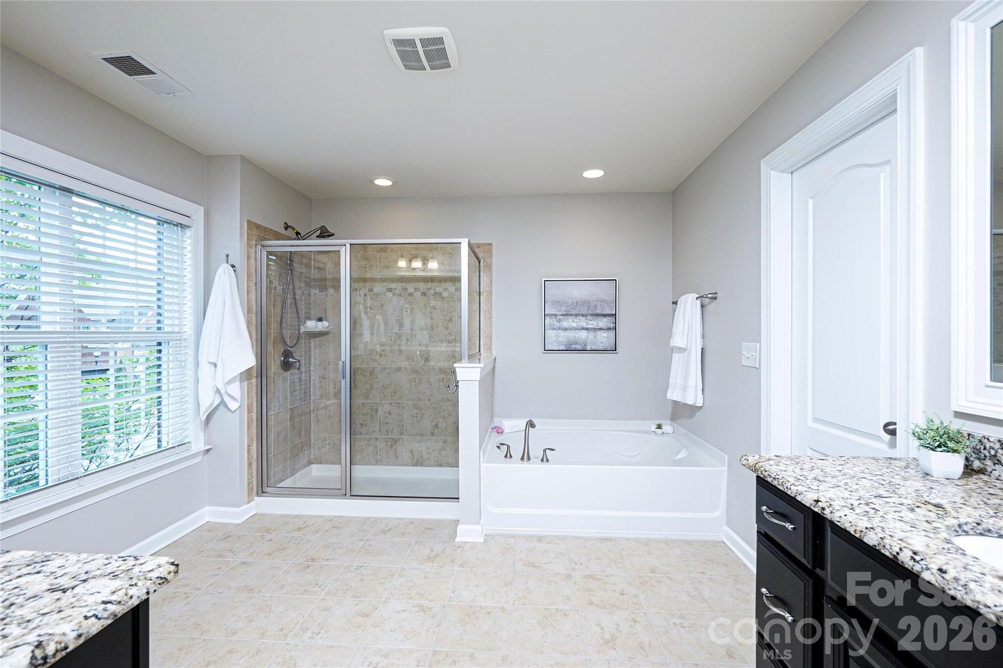 4008 Oxford Mill Road Waxhaw, NC 28173 - Photo 26 of 44 a bathroom with a granite countertop tub sink and shower