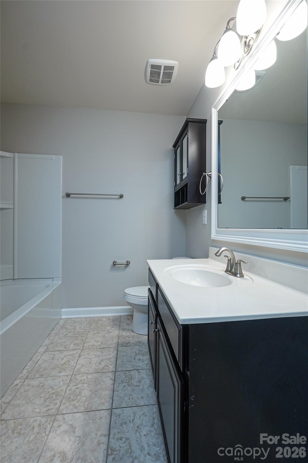 4008 Oxford Mill Road Waxhaw, NC 28173 - Photo 32 of 44 a bathroom with a sink a mirror and a bathtub