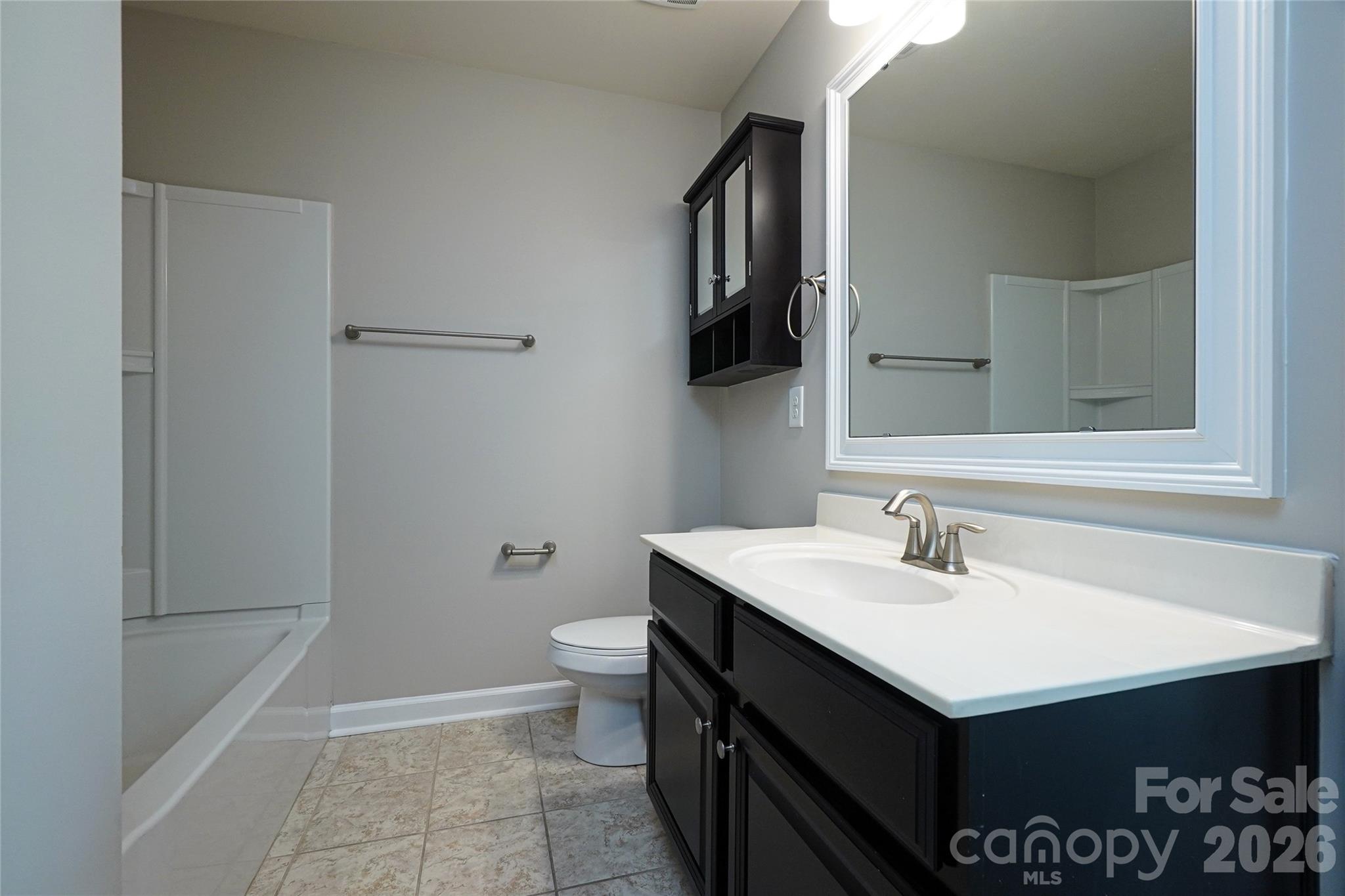 4008 Oxford Mill Road Waxhaw, NC 28173 - Photo 33 of 44 a bathroom with a sink vanity and toilet