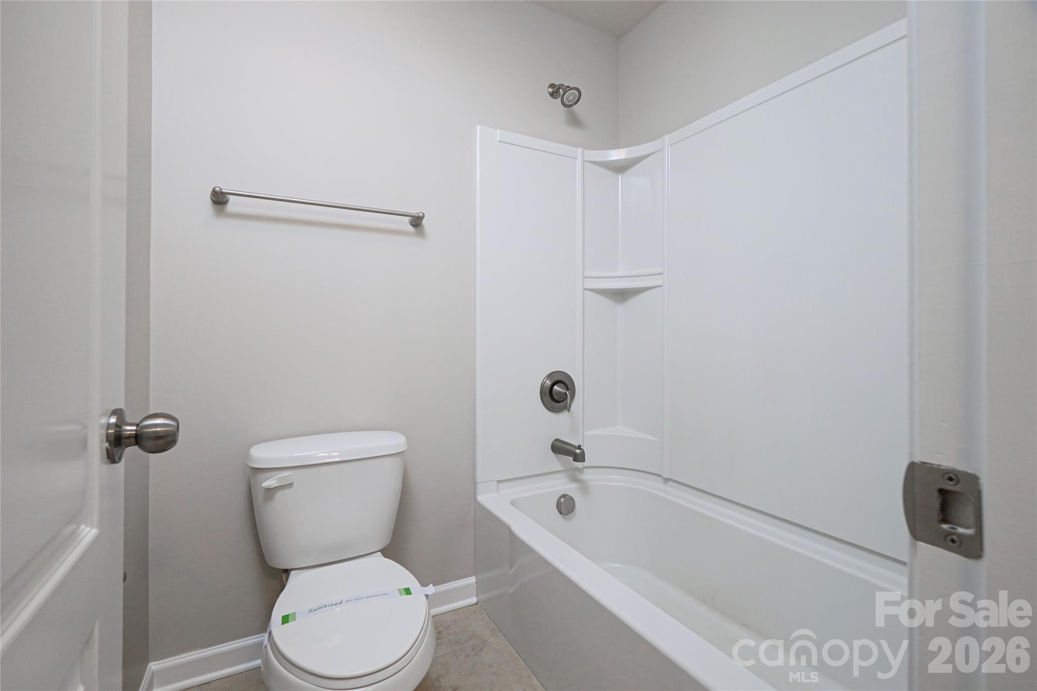 4008 Oxford Mill Road Waxhaw, NC 28173 - Photo 39 of 44 a white toilet sitting next to a bath tub