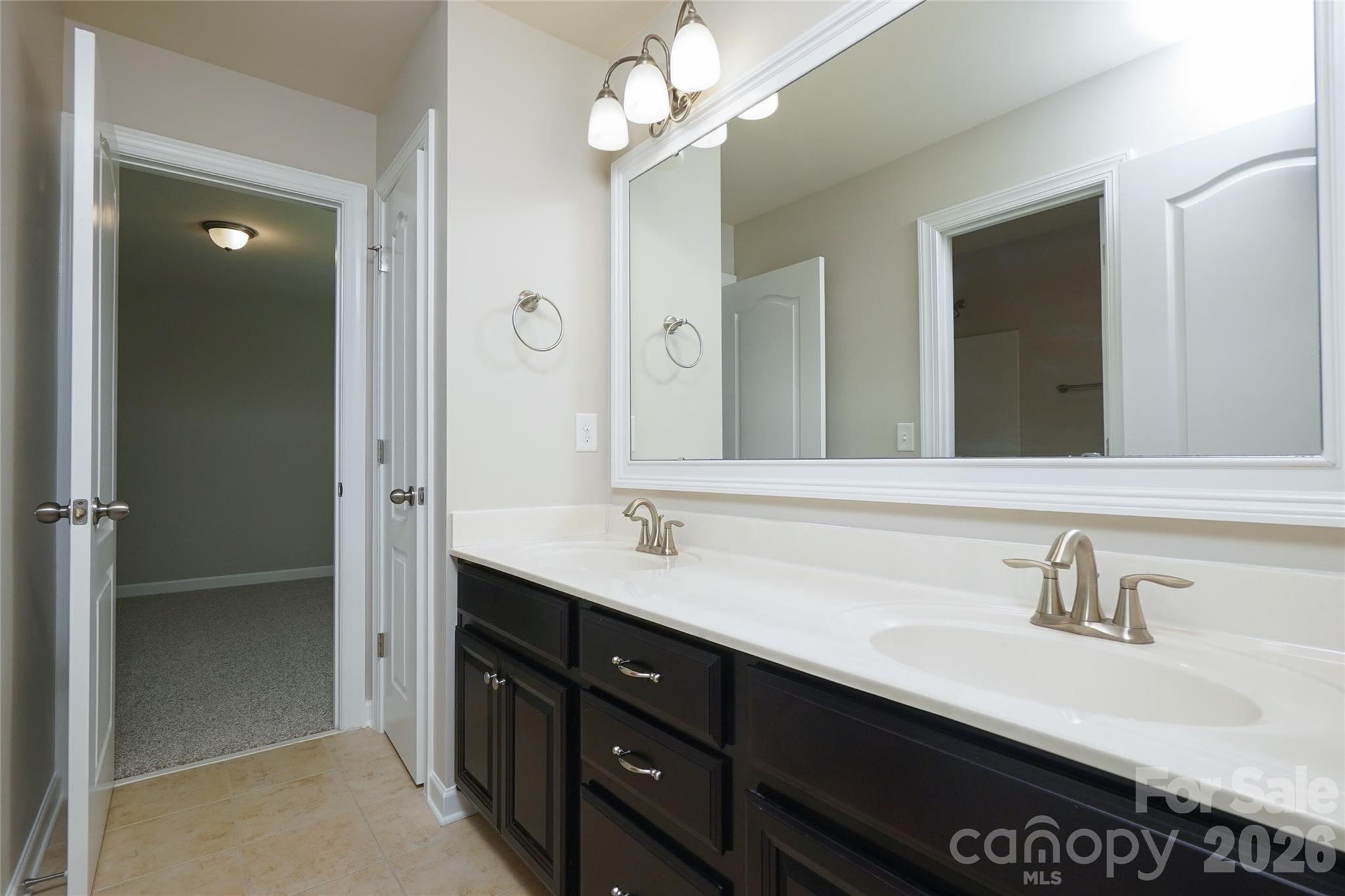 4008 Oxford Mill Road Waxhaw, NC 28173 - Photo 40 of 44 a bathroom with a sink double vanity and a mirror