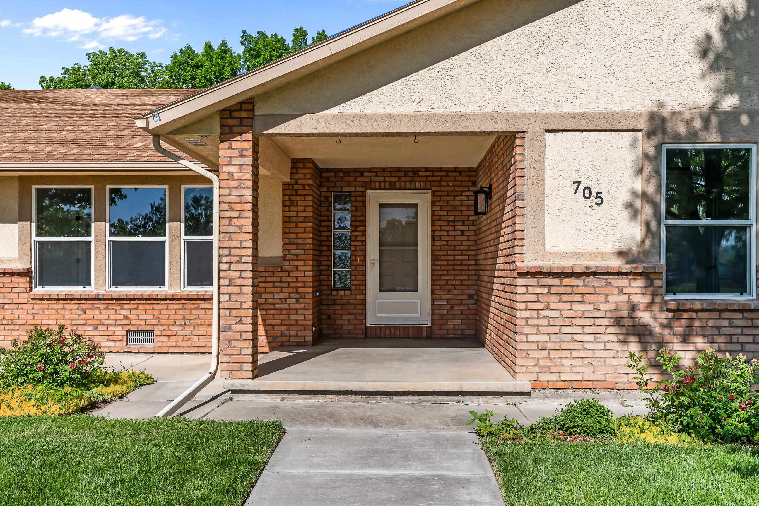 705-24 24 3/4 Road Grand Junction, CO 81505 - Photo 2 of 27 a front view of a house with a garden