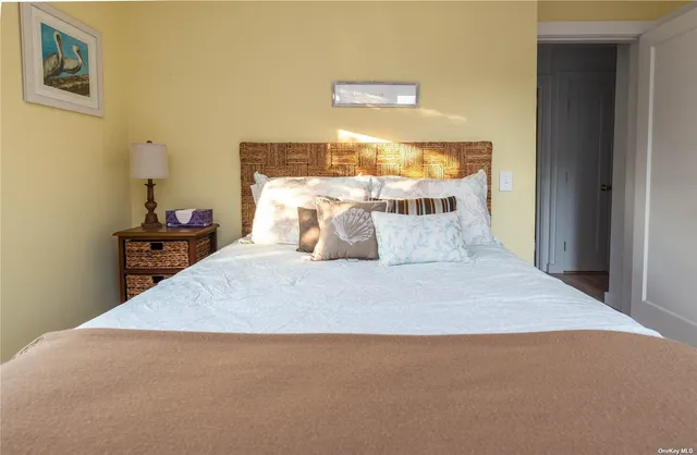 a large bed sitting in a bedroom next to a window