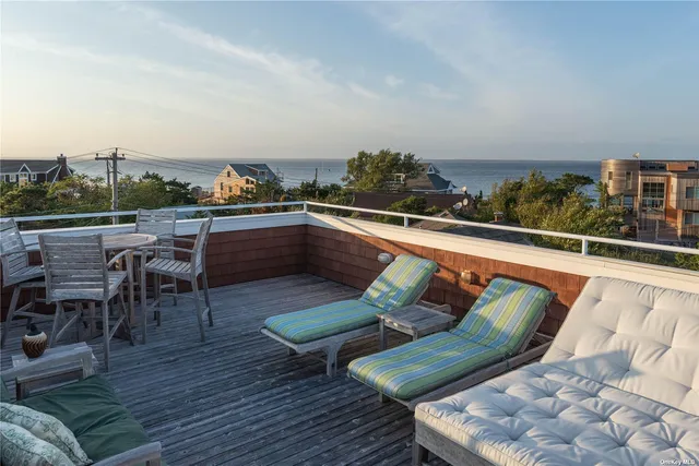 an outdoor sitting area with furniture