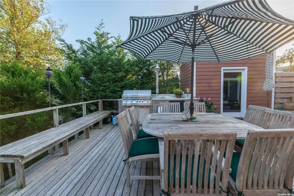a view of a roof deck with table and chairs