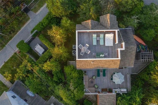 an aerial view of a house with a yard and balcony