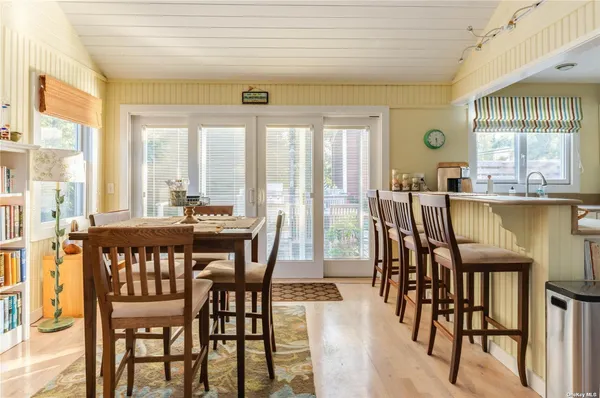 a view of a dining room with furniture and windows