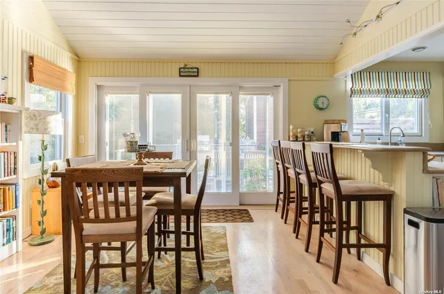 a view of a dining room with furniture and windows