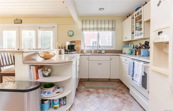 a kitchen with a sink a stove and cabinets