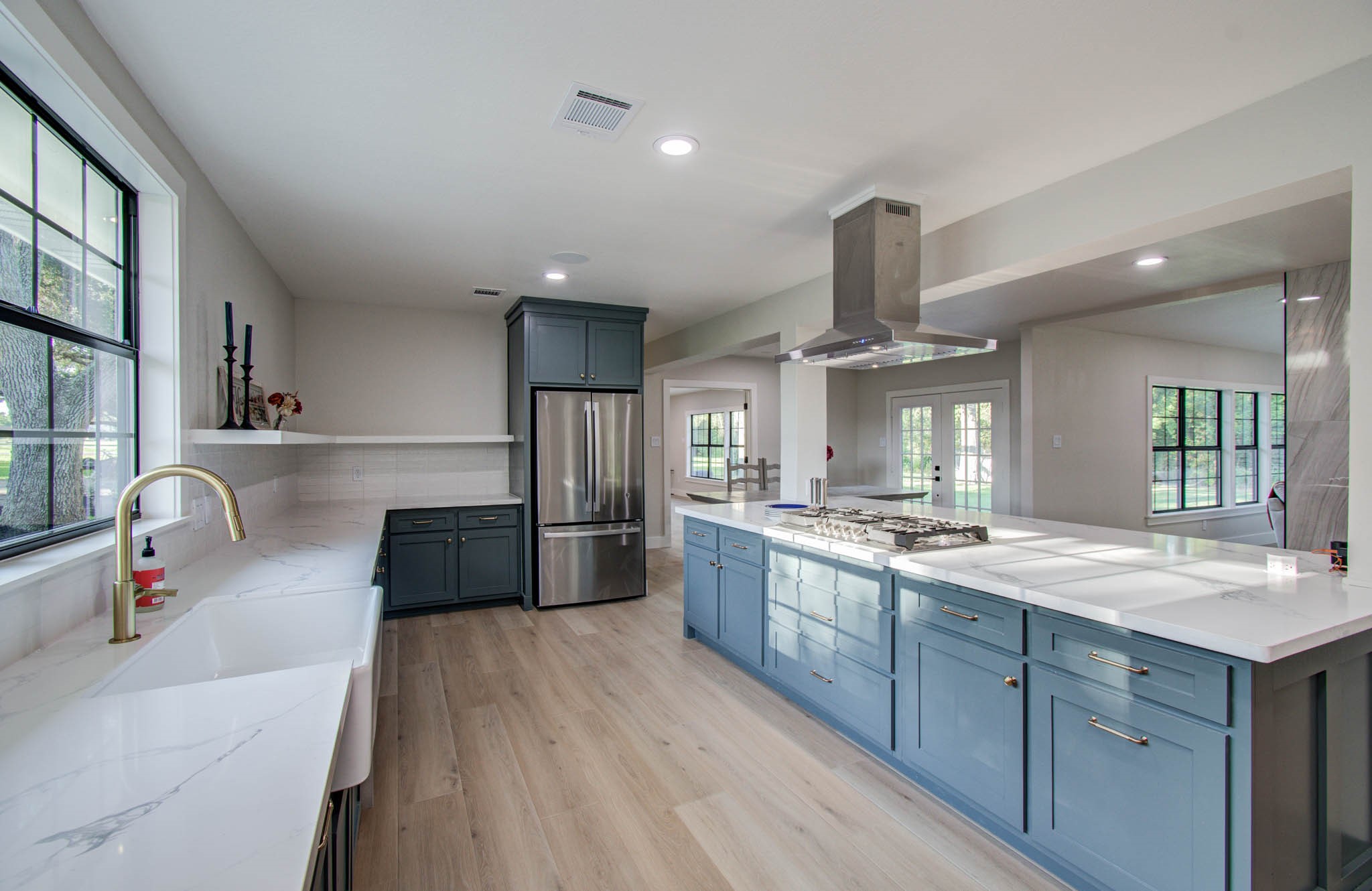a kitchen with stainless steel appliances granite countertop a sink dishwasher stove and refrigerator