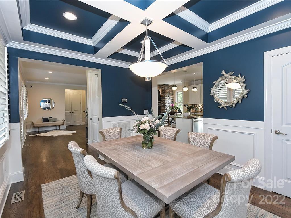 801 Sedgefield Road Charlotte, NC 28209 - Photo 12 of 30 a dining room with furniture a chandelier and wooden floor