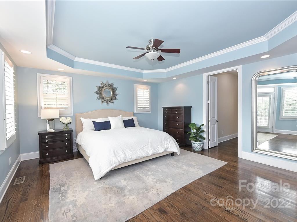 801 Sedgefield Road Charlotte, NC 28209 - Photo 13 of 30 a spacious bedroom with a large bed and wooden floor