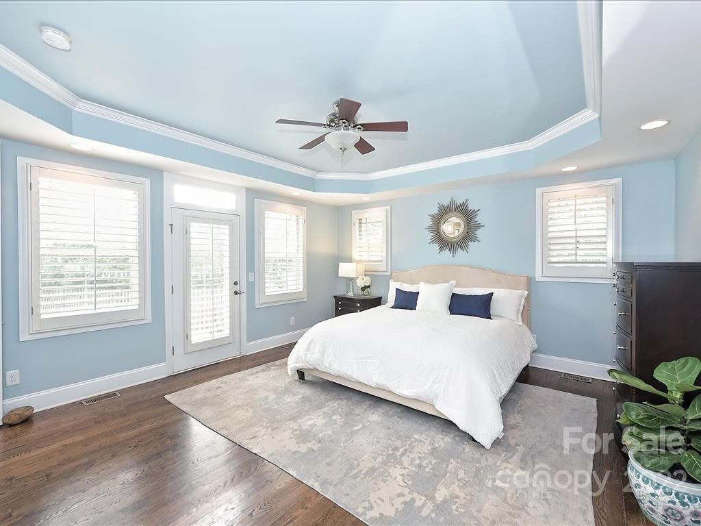 801 Sedgefield Road Charlotte, NC 28209 - Photo 14 of 30 a bedroom with a large bed and wooden floor